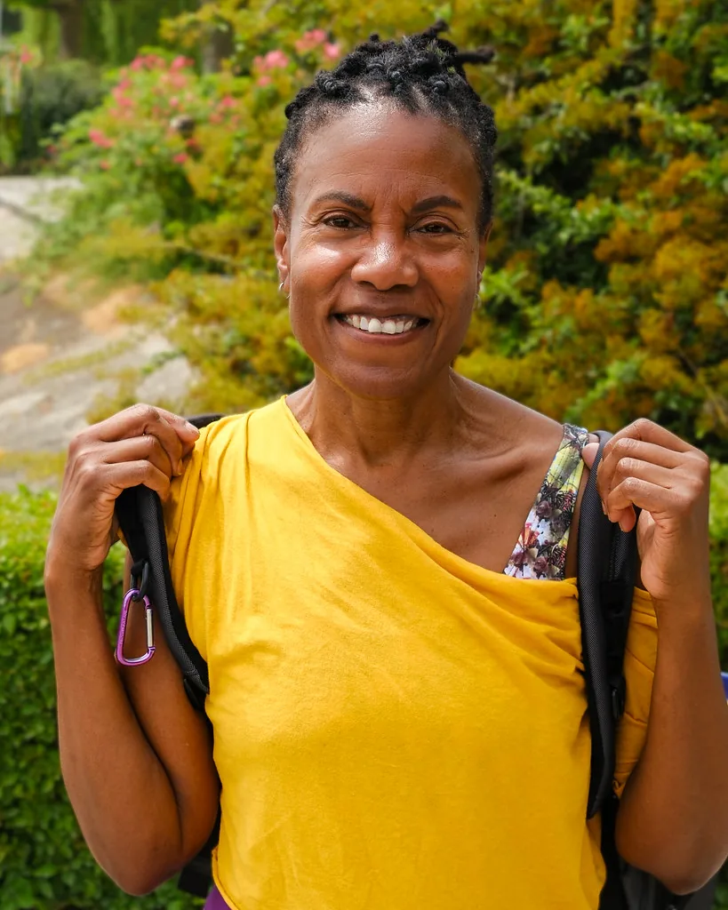 A woman in a yellow top outdoors